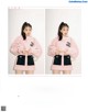 A woman in a pink sweater and skirt posing for a magazine.