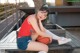 A woman sitting on a bench holding a basketball.